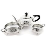 An Arts and Crafts silver three piece tea service in the Art Nouveau style,