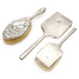 A silver Art Deco hand mirror and brush,