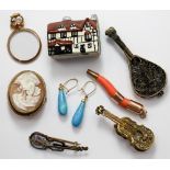 Two enamelled brooches, one in the shape of a violin,