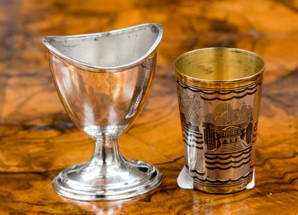 A small copper coloured Niello tumbler showing an early 20th Century battleship,