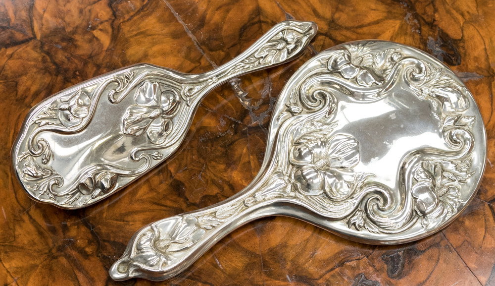 A French circa 1920s, white metal embossed , two piece dressing table set,