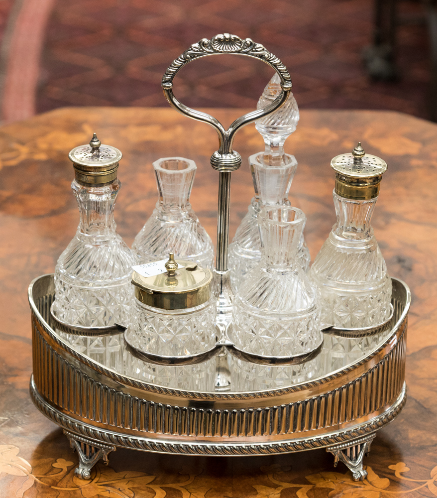 An Elkington six piece silver plated cruet stand complete with six bottles (two stoppers missing)