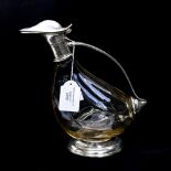 A Peltro duck shaped claret jug,