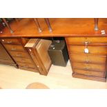 A contemporary oak pedestal desk, fitted with ten short drawers,