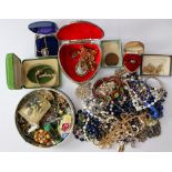 A collection of costume jewellery within two tins.