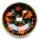 A Moorcroft grapes and vine bowl, measuring approx 21.5 cm diameter across the top edge, signed W.