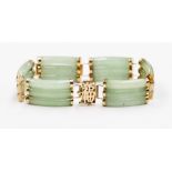 A 14ct gold jadeite set three row bracelet with yellow metal details and Chinese lettering to the