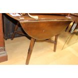 An Ercol elm topped drop-leaf dining table,