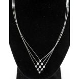 An 18ct white gold and diamond three strand wire necklace,