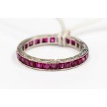 A ruby set platinum full eternity ring, channel set with square cut rubies,