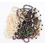 A collection of various coloured pearl strands, multi strands and single rows in different lengths,