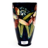 A cobalt blue Moorcroft tripod vase with orchid pattern