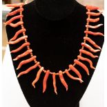 An orange and white coral necklace, with alternate branch coral and round coral beads. Approx 20.