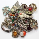 A collection of eighteen brooches with various designs including stone set and 'miracle' brooches,