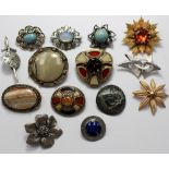 A collection of fourteen brooches of assorted design to include a Tritan broach,