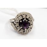 An amethyst and diamond cluster 9ct white gold ring with diamond set cross over shoulders.