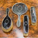 A Tortoise shell pique work inlaid four piece dressing table set, comprising hand mirror,