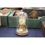 A brass German Kundo skeleton clock with glass dome cover