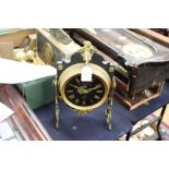 A French mantle clock, by Systeme Brevette, the black dial with brass Roman numerals,