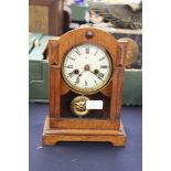 An early 20th Century oak and pine cased mantle clock, having an eight day movement,