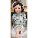 An Armand Marseille bisque head doll with blue glass sleeping eyes, open mouth, brown mohair wig,