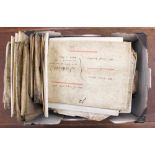 A box containing a large collection of vellum indentures, approximately thirty in total,