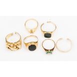 A selection of six gold rings comprising of two 9ct gold and hard stone set signet rings,