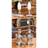 A pair of French silver plated candlesticks - ecclesiastical - converted to lamps
