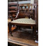 A 19th Century rosewood and inlaid low chair on castors