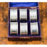 A boxed set of six silver napkin rings,