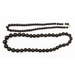 Two strings of ebony beads, one with approx 15mm beads with a length of approx 24'',