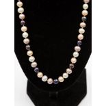 A coloured cultured pearl single row necklace with silver gilt clasp, approx 18'' long.