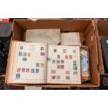 A box of stamp albums and loose stamps