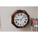 A 20th Century mahogany octagonal cased wall clock, with black Roman numerals, on a white dial,