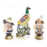 A Staffordshire pigeon figure and two manor house dwarfs