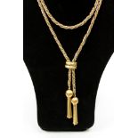 An 18ct two colour gold rope twist drop necklace with bead detail and tassel and a fancy claps at