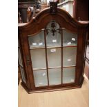 An early 20th century walnut veneered wall cabinet