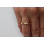 A diamond solitaire 18ct. gold ring, the round brilliant cut diamond approx 0.10ct.,.