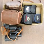 A collection of cameras and binoculars