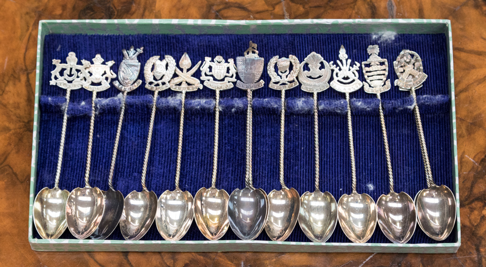 A set of fourteen silver teaspoons, all bearing names and crests of the states of Malaysia,