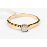 A diamond solitaire 18ct. gold ring, the round brilliant cut diamond approx 0.