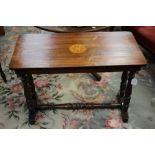 A Victorian mahogany silver table, raised on turned columns, standing on platform bases,