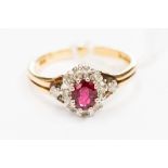 An oval ruby and diamond 18ct yellow gold cluster ring,