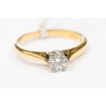 A diamond solitaire 18ct yellow gold ring, the round brilliant cut diamond approx 0.