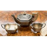 A three piece silver teaset, the teapot having fruitwood handle and finial, Sheffield 1934,