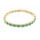 An emerald and diamond set 18ct yellow gold line bracelet,