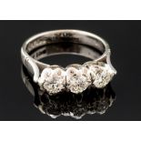 A diamond three stone 18ct white gold ring,