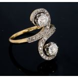 A two stone diamond S scroll head 18ct yellow gold and platinum set ring,