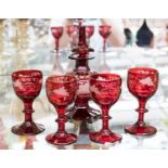 A mid 19th century Bohemian ruby flashed glass scent flagon and four unassociated spirit glasses,