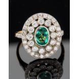 An emerald and diamond three tier oval cluster 18ct gold ring,